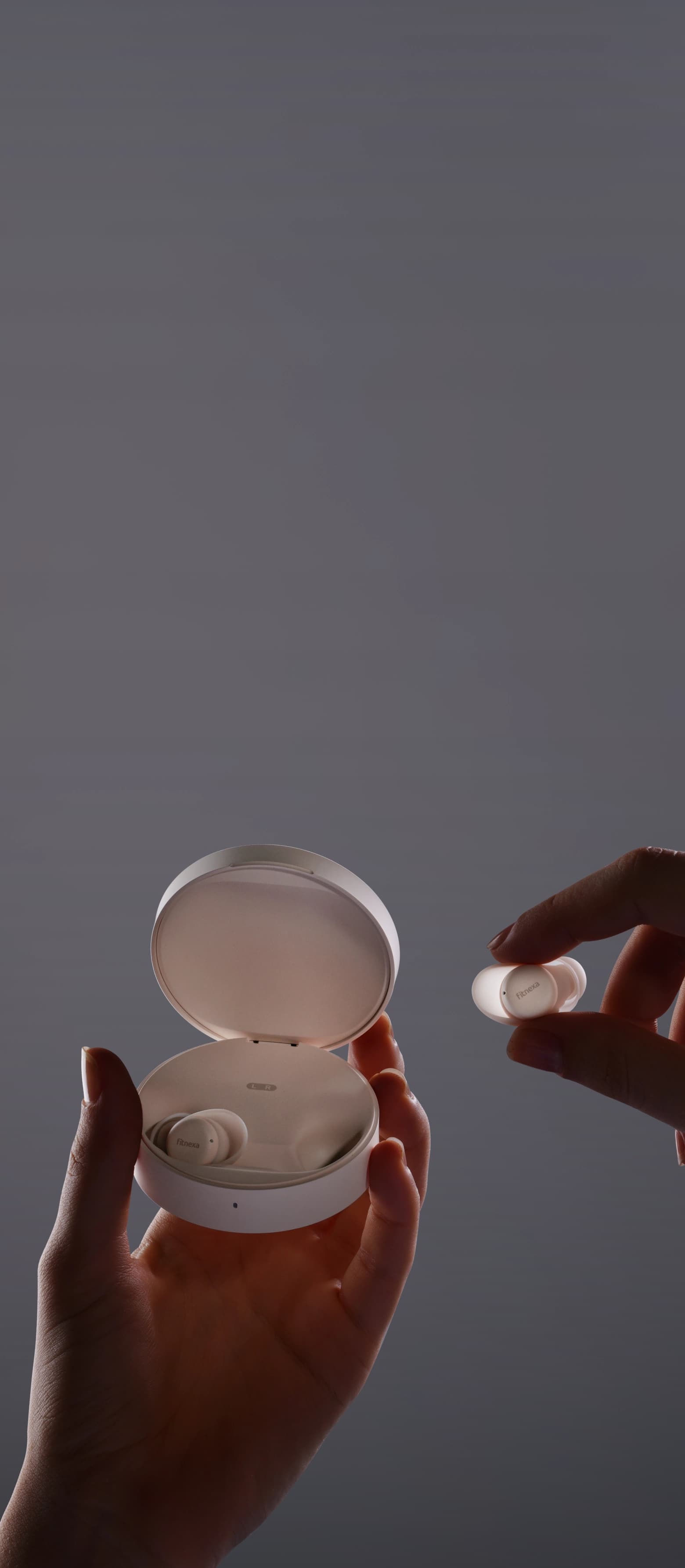 Hands holding Fitnexa charging case and earbud