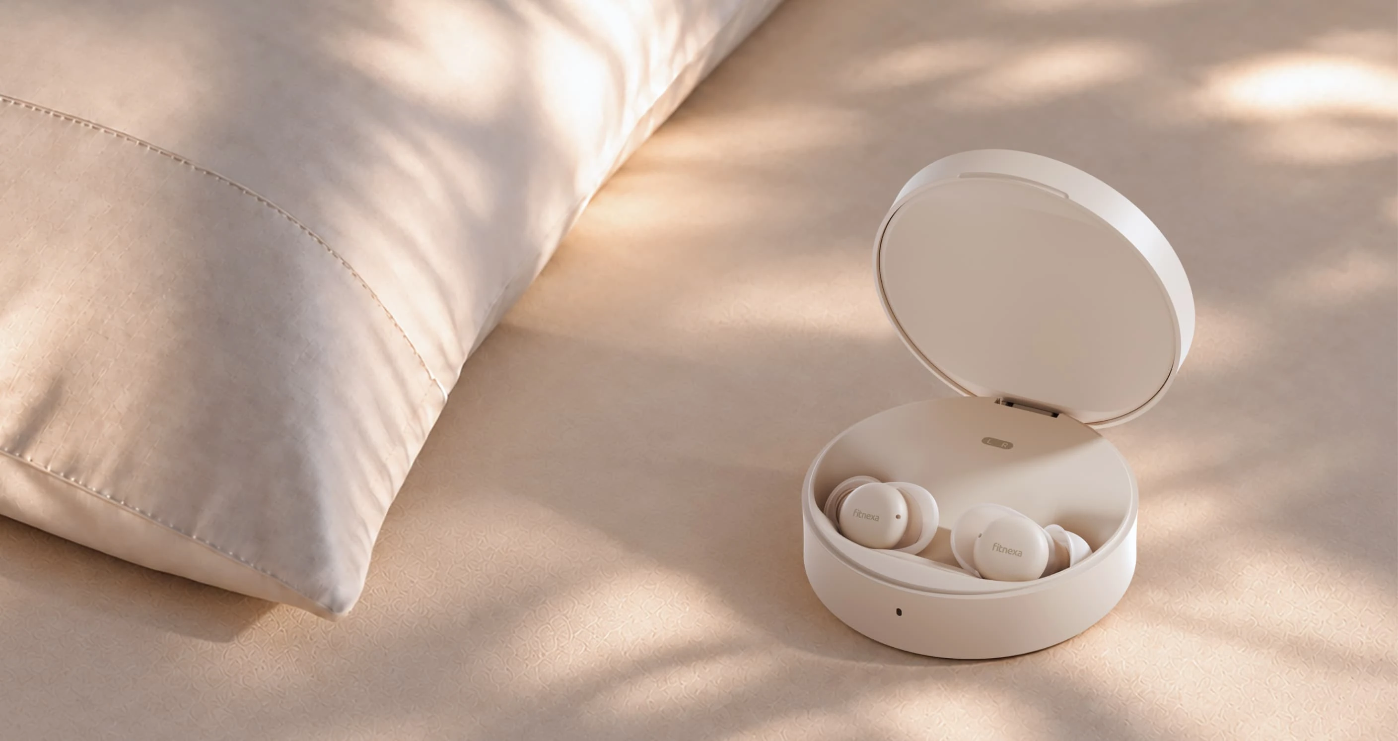 SomniPods 3 earbuds in their charging case on soft bedding